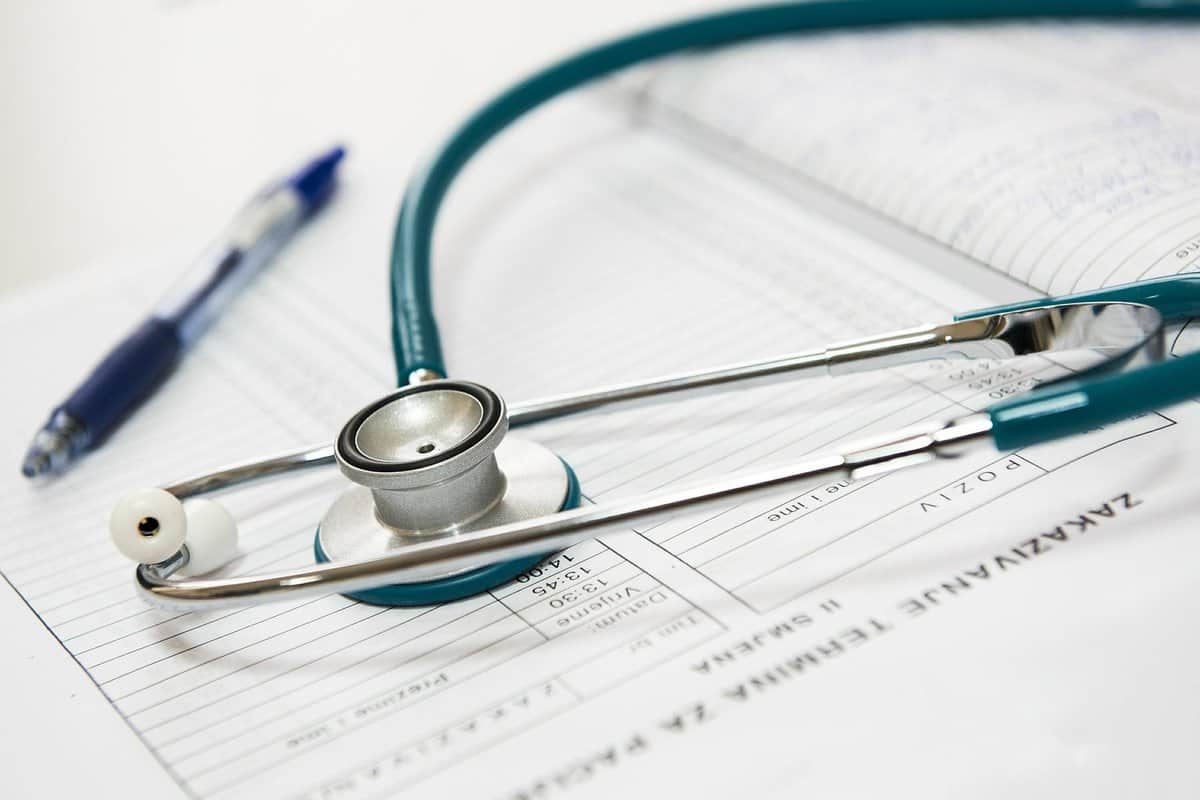 a stethoscope laying on top of a medical paper.